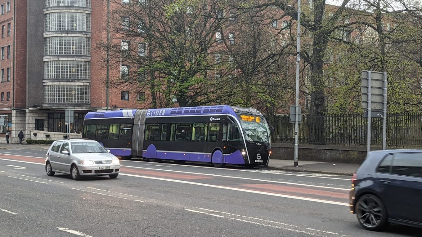 A Glider bus parked at the side of the road in Belfast City Centre