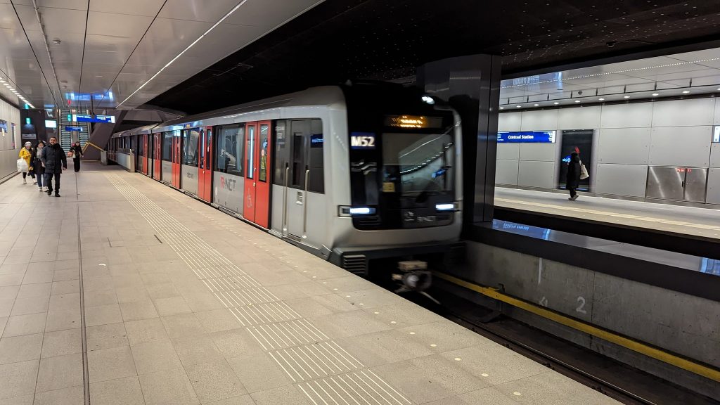 An M52 Metro train arrives at Amsterdam Centraal.