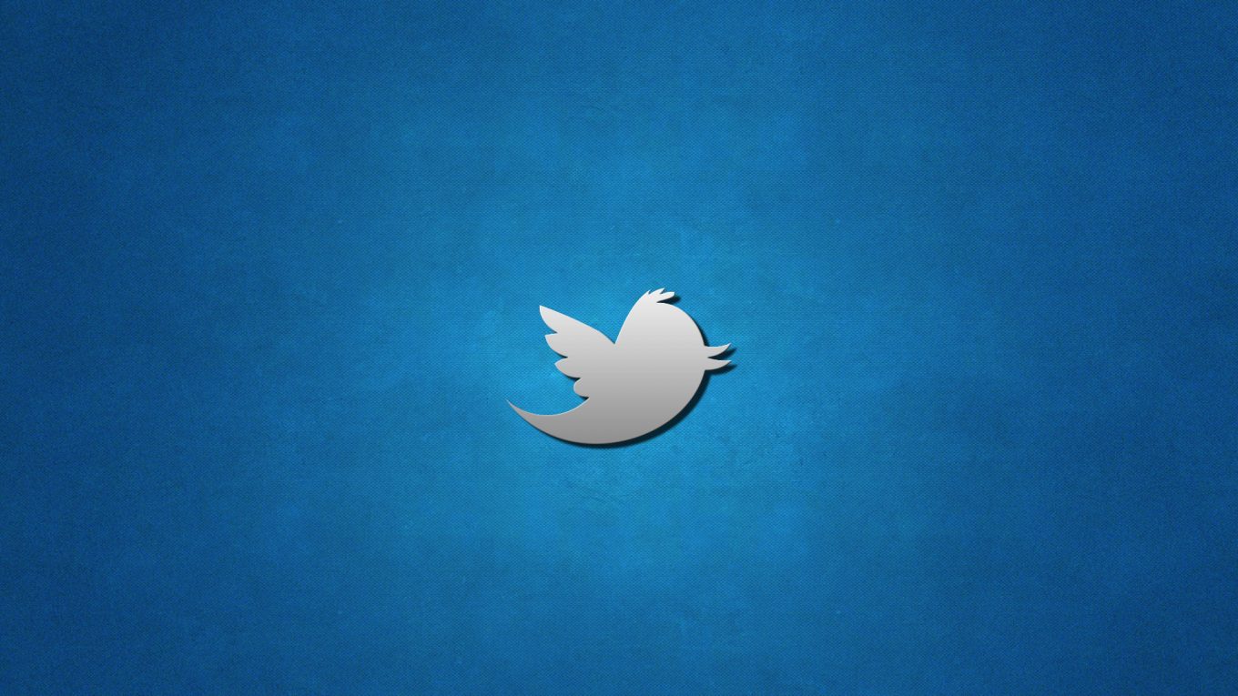 A silver Twitter logo on a gradient blue background.