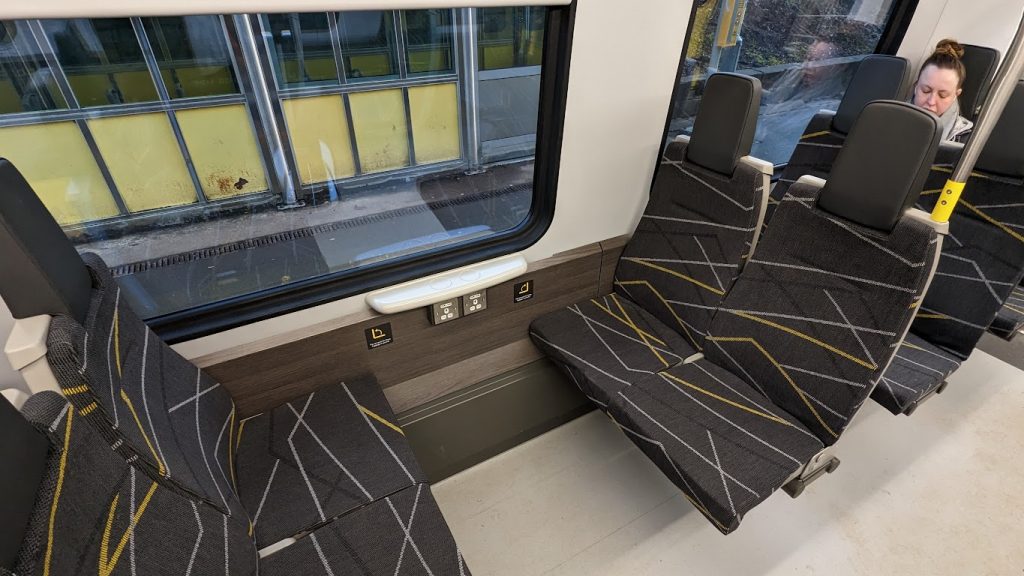 The multi-use space on a class 777 train. There are four seats - they can be founded to create more space, but in this photo they are all lowered.